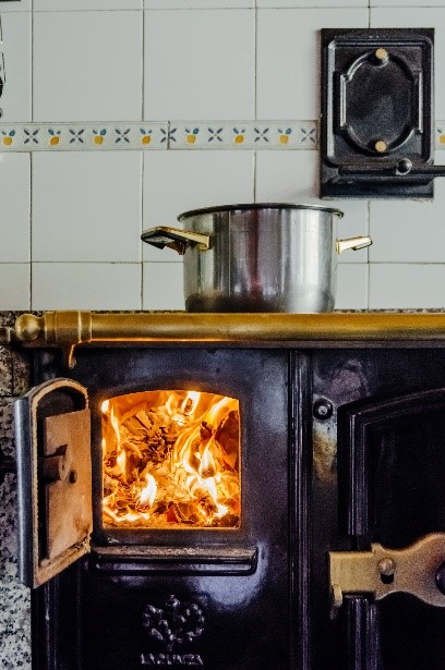A frying pan over a wood-burning stove