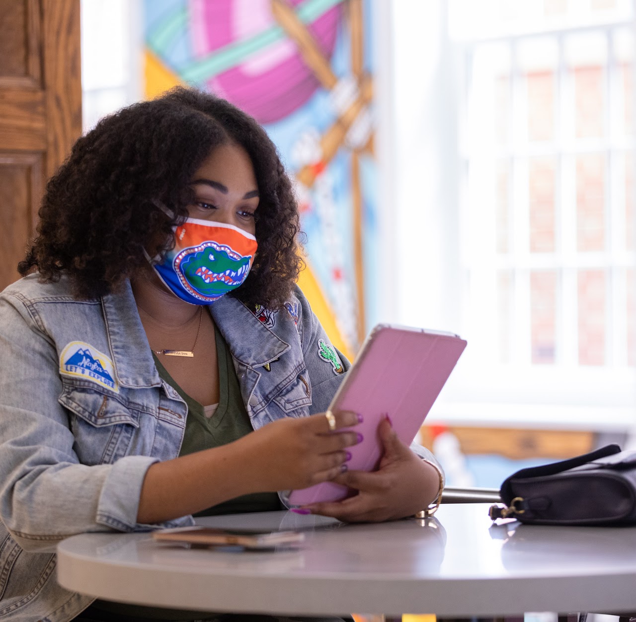 student with pink ipad